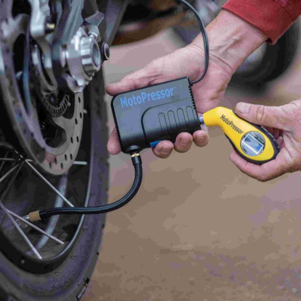 Pocket pump connected to motor bike and pressure gauge connected